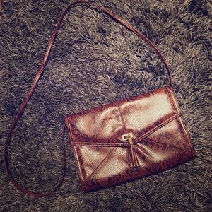 Brown snake skin print clutch bag